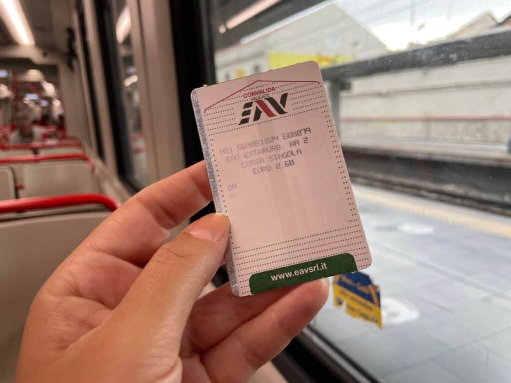 train ticket and interior of regional train from Naples to Pompeii